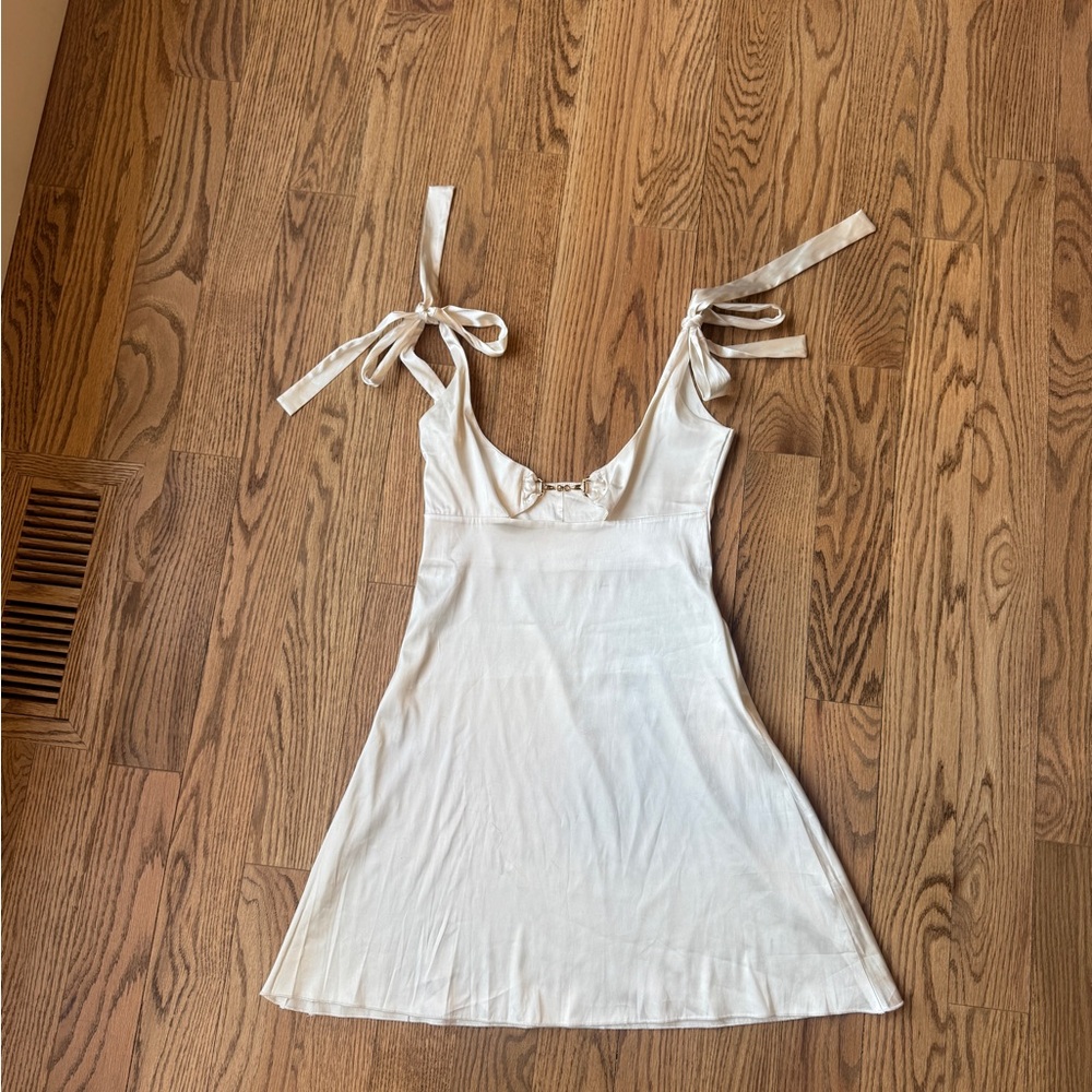 Chic White Dress with Bow Straps and Gold Snaffle Bit